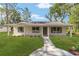 Charming single-story home with a well-manicured lawn and inviting walkway at 5400 Nw 9Th St, Ocala, FL 34482