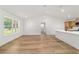 Bright living room features wood flooring, white walls, and an open floor plan to the kitchen at 5400 Nw 9Th St, Ocala, FL 34482
