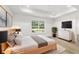 Main bedroom with tray ceiling, large window, and modern furnishings at 5400 Nw 9Th St, Ocala, FL 34482