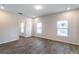 Bright bedroom with wood-look flooring, ample natural light, and neutral walls at 585 Marion Oaks Pass, Ocala, FL 34473