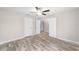 Spacious bedroom featuring wood-look floors, a ceiling fan, and multiple entryways at 5908 Sw 111Th Place Rd, Ocala, FL 34476