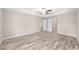 An empty bedroom with wood-look floors and a tray ceiling at 5908 Sw 111Th Place Rd, Ocala, FL 34476