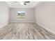 A large bedroom featuring wood-look floors and a window at 5908 Sw 111Th Place Rd, Ocala, FL 34476