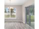 Sunlit dining area featuring a glass sliding door and modern chandelier at 5908 Sw 111Th Place Rd, Ocala, FL 34476