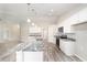 Modern kitchen features a large island with granite countertop and stainless steel appliances at 5908 Sw 111Th Place Rd, Ocala, FL 34476