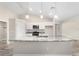 A kitchen with white cabinets, grey countertops, stainless steel appliances, and an island at 5908 Sw 111Th Place Rd, Ocala, FL 34476