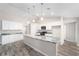 Bright kitchen with white cabinets, granite counters, stainless appliances and pendant lighting at 5908 Sw 111Th Place Rd, Ocala, FL 34476