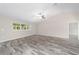 Bright living room with neutral walls, vaulted ceiling and wood-look flooring at 5908 Sw 111Th Place Rd, Ocala, FL 34476