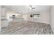 Open-concept living space with modern flooring and sleek kitchen at 5908 Sw 111Th Place Rd, Ocala, FL 34476