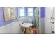 Cozy bathroom featuring colorful shower curtain, a sink, and ample storage at 626 Ne 21St St, Ocala, FL 34470