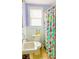 Charming bathroom featuring colorful shower curtain, a sink, and ample natural light at 626 Ne 21St St, Ocala, FL 34470