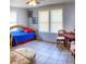 Bright bedroom featuring tile floors, bright furniture, and natural light from two windows at 626 Ne 21St St, Ocala, FL 34470
