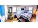 Inviting bedroom with tile flooring, vintage furniture, corner shelves, and ample natural light at 626 Ne 21St St, Ocala, FL 34470
