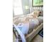 Comfortable bedroom featuring a cozy patchwork quilt and throw pillows at 626 Ne 21St St, Ocala, FL 34470