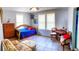 Well-lit bedroom featuring tile floors, bright furniture, and natural light from two windows at 626 Ne 21St St, Ocala, FL 34470