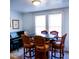 Bright dining room featuring a table with six chairs and a piano in the corner at 626 Ne 21St St, Ocala, FL 34470