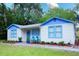 Inviting home with colorful trim, landscaped front yard, and a cozy seating area on the porch at 626 Ne 21St St, Ocala, FL 34470
