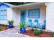 Welcoming front porch with seating, colorful accents, and a beautifully landscaped garden at 626 Ne 21St St, Ocala, FL 34470