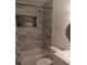Nicely remodeled bathroom with marble tile surround in shower and tub combo at 6415 Ne 23Rd Ave, Ocala, FL 34479