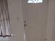 A clean, bright entryway featuring a white door and neutral walls at 6415 Ne 23Rd Ave, Ocala, FL 34479