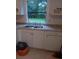 Bright kitchen with white cabinets, granite countertops, and stainless steel sink at 6415 Ne 23Rd Ave, Ocala, FL 34479