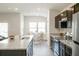 Modern kitchen with stainless steel appliances, granite countertops, and a breakfast bar overlooking the dining area at 6865 Sw 153 Place Rd, Ocala, FL 34473