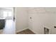 Convenient laundry room with utility connections and overhead shelving, adjacent to the kitchen and living area at 6865 Sw 153 Place Rd, Ocala, FL 34473