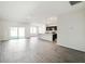 Spacious open-concept living room seamlessly connects to the modern kitchen and features sliding glass doors to the backyard at 6865 Sw 153 Place Rd, Ocala, FL 34473