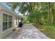 Back exterior of home featuring a spacious brick patio, perfect for outdoor dining and entertaining at 7242 Sw 115Th Pl, Ocala, FL 34476