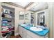 Bathroom with double sinks, vanity, and shelving for ample storage at 7242 Sw 115Th Pl, Ocala, FL 34476