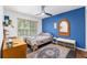Cozy bedroom featuring a ceiling fan, desk, and window with natural light at 7242 Sw 115Th Pl, Ocala, FL 34476