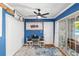 Bright breakfast nook with custom wall art, casual seating, and sliding doors to the sunroom at 7242 Sw 115Th Pl, Ocala, FL 34476