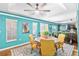 Dining room with hardwood floors, large windows, turquoise walls, and tray ceiling at 7242 Sw 115Th Pl, Ocala, FL 34476