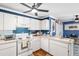 Well-lit kitchen with white cabinets, blue backsplash, modern appliances, and ample counter space at 7242 Sw 115Th Pl, Ocala, FL 34476