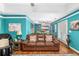 Comfortable living room with brown leather sofa and colorful accents, open to the kitchen at 7242 Sw 115Th Pl, Ocala, FL 34476