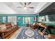 Open living room featuring comfortable seating, a ceiling fan, and colorful walls at 7242 Sw 115Th Pl, Ocala, FL 34476