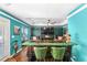 Entertainment room features a unique bar setup, comfortable seating, and hardwood flooring at 7242 Sw 115Th Pl, Ocala, FL 34476