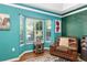 Bright living room with bay window, cozy armchair, and hardwood floors at 7242 Sw 115Th Pl, Ocala, FL 34476