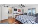 Comfortable main bedroom with hardwood floors, ceiling fan, and access to the bathroom at 7242 Sw 115Th Pl, Ocala, FL 34476