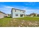 Exterior view of backyard with covered patio and lush green lawn at 7695 Sw 64Th Street Rd, Ocala, FL 34474