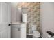 Stylish powder room with patterned wallpaper, modern fixtures, and elegant vanity at 7695 Sw 64Th Street Rd, Ocala, FL 34474