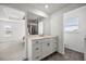 Bathroom with double vanity, stylish fixtures, and ample natural light from a large window at 7695 Sw 64Th Street Rd, Ocala, FL 34474