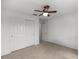 A bedroom featuring a ceiling fan and a closet with white sliding doors at 7695 Sw 64Th Street Rd, Ocala, FL 34474
