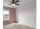 Bright bedroom featuring a ceiling fan, neutral carpet, and a window offering natural light at 7695 Sw 64Th Street Rd, Ocala, FL 34474