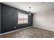 Well-lit empty room with tiled flooring, a modern light fixture, and a large window at 7695 Sw 64Th Street Rd, Ocala, FL 34474
