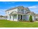 Side view of a two-story home featuring well-maintained landscaping and a welcoming front porch at 7695 Sw 64Th Street Rd, Ocala, FL 34474