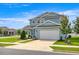 Beautiful two-story home with lush landscaping, a two-car garage, and a welcoming front porch at 7695 Sw 64Th Street Rd, Ocala, FL 34474