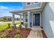 Inviting front porch featuring stylish seating and lush landscaping, enhancing curb appeal at 7695 Sw 64Th Street Rd, Ocala, FL 34474