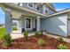 Charming front porch with stylish seating and meticulous landscaping, adding to the home's appeal at 7695 Sw 64Th Street Rd, Ocala, FL 34474