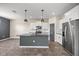 Open kitchen with granite countertops, stainless steel appliances, and center island at 7695 Sw 64Th Street Rd, Ocala, FL 34474